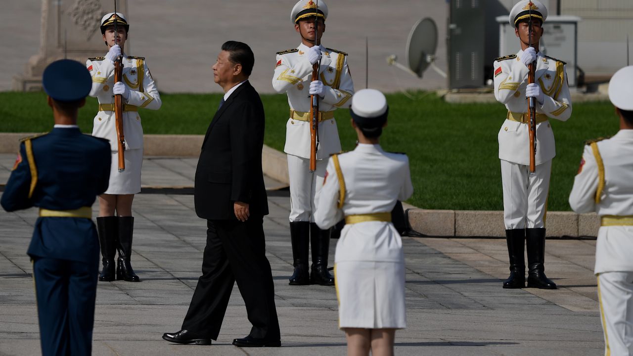 Chinese President Xi Jinping walks to the Monument to the People's Heroes during a wreath laying ceremony to honour deceased national heroes on Martyrs Day in Beijing's Tiananmen Square on September 30.