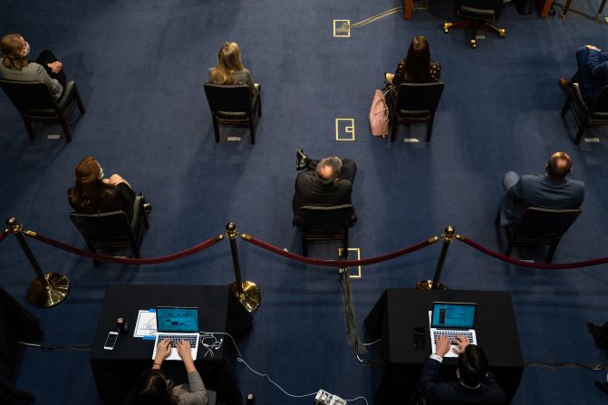 People practice social distancing during the hearing on October 14.