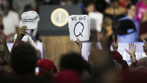 An attendee at a Trump rally holds up a QAnon sign on August 4, 2018. (Bloomberg via Getty Images)