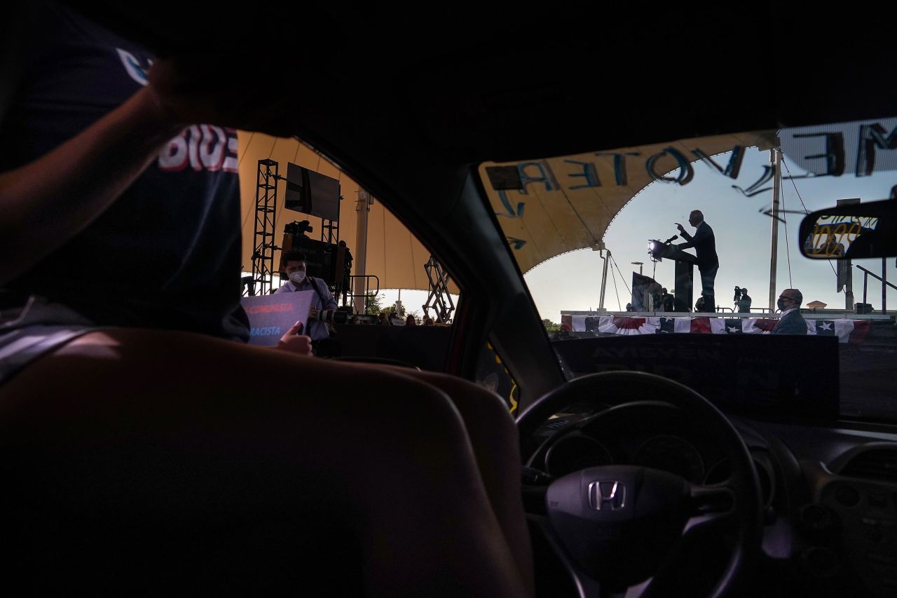 Biden is seen through the windshield of a car while speaking at a campaign event in Miramar, Florida, on October 13.