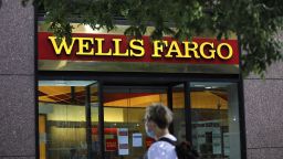 A pedestrian wearing a protective mask walks past a Wells Fargo & Co. bank branch in New York, U.S., on Thursday, July 9, 2020. Wells Fargo is scheduled to release earnings figures on July 14. Photographer: Peter Foley/Bloomberg via Getty Images