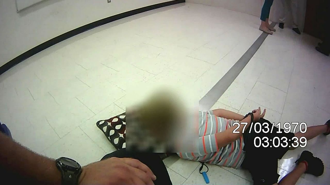 The lawsuit alleges the boy was held on the ground, handcuffed, for more than 38 minutes. 