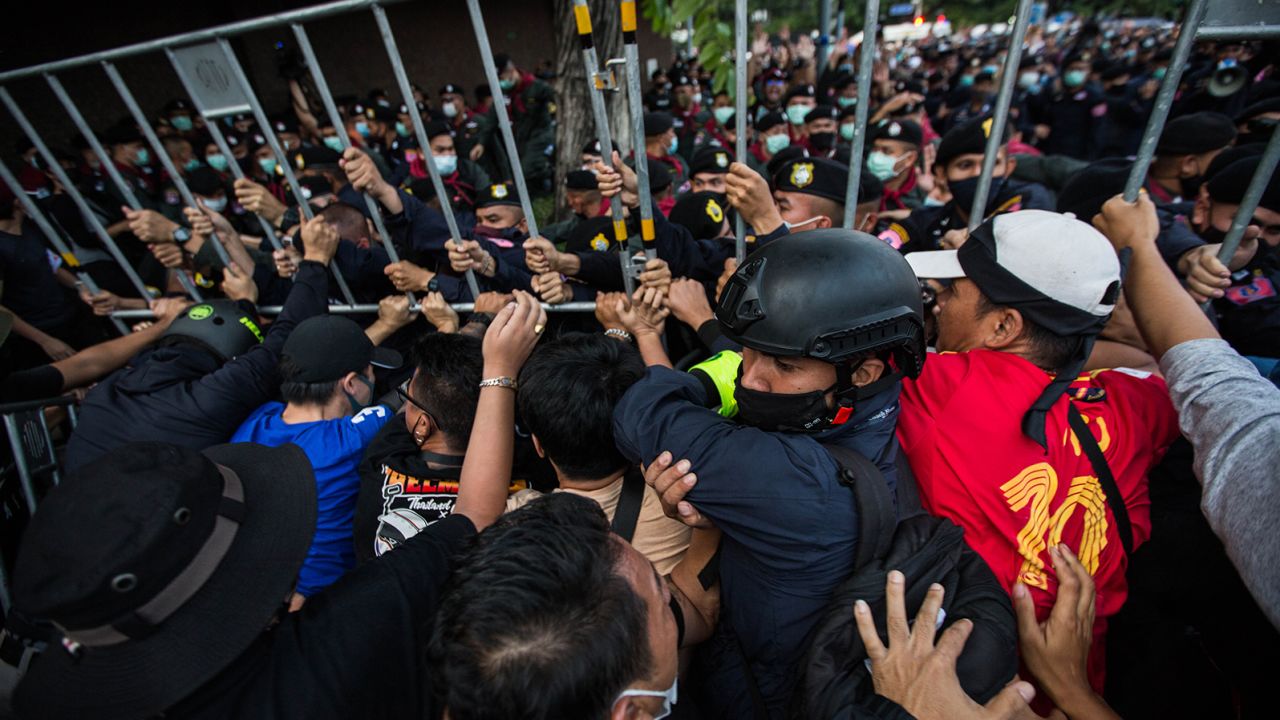 Pro-democracy protesters seen pushing back Thai police during an anti-government demonstration on October 14, 2020 in Bangkok, Thailand. 