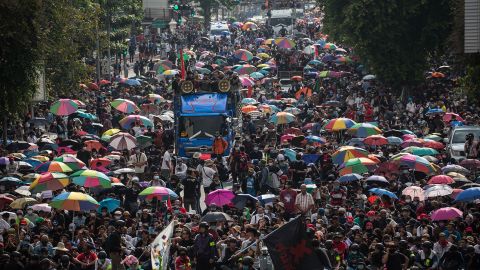 Protesters seen walking toward Government House during an anti-government demonstration in Bangkok.