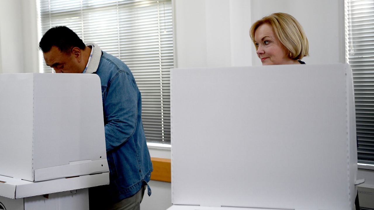 National Party leader Judith Collins and husband David Wong-Tung vote on October 4, 2020, in Auckland, New Zealand. 