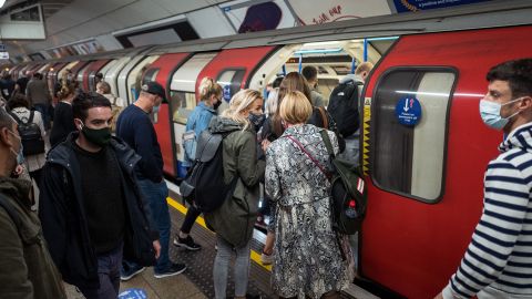 Commuters wearing masks crowd on to a London tube train on September 23. The city will enter the "high" alert level on Saturday, meaning a ban on households mixing indoors.