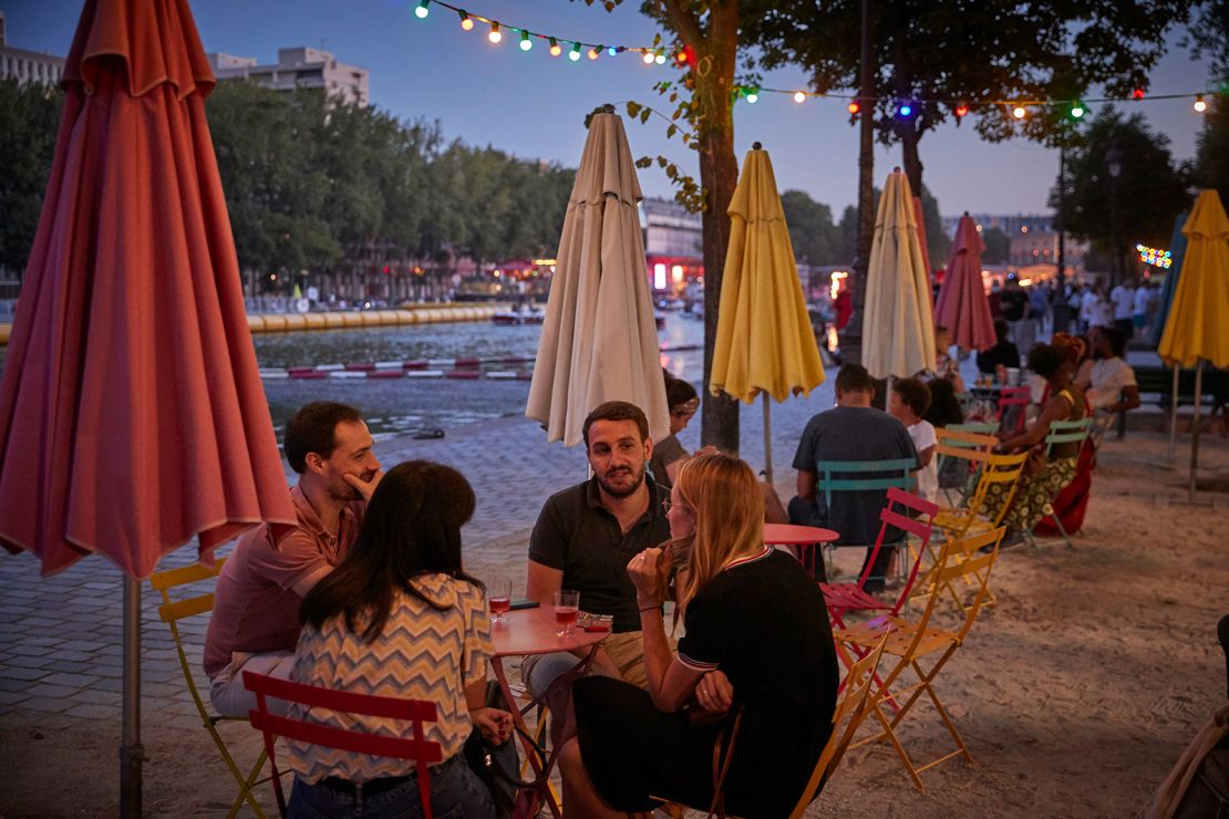 Parisians enjoy a socially distanced opening night of Paris Plages at La Villette on July 18. The city and several others will now face a 9 p.m. to 6 a.m. curfew.