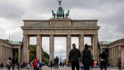 Tourists walk at the Brandenburg Gate in Berlin, Germany on October 12, as gatherings were limited to 10 people and an 11 p.m. curfew imposed in several regions.