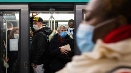 Morning rush hour commuters wear protective face masks on a packed train at Champs-ElyseesClemenceau metro station in Paris, France, on Wednesday, Oct. 14, 2020. After putting six cities including Paris on maximum alert,?President Macron Macron may announce additional restrictions on French national television today. Photographer: Nathan Laine/Bloomberg via Getty Images