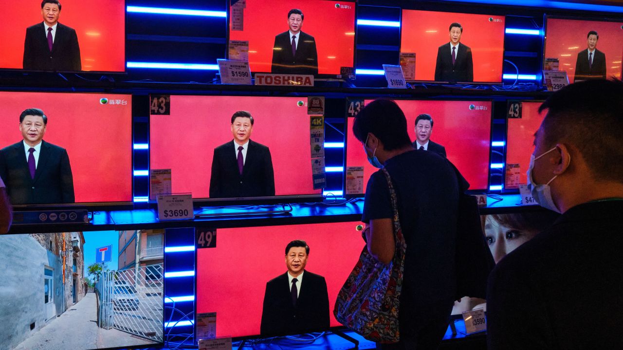 Screens at a department store are seen showing a news broadcast of Chinese President Xi Jinping delivering a speech in Shenzhen on October 14, 2020.