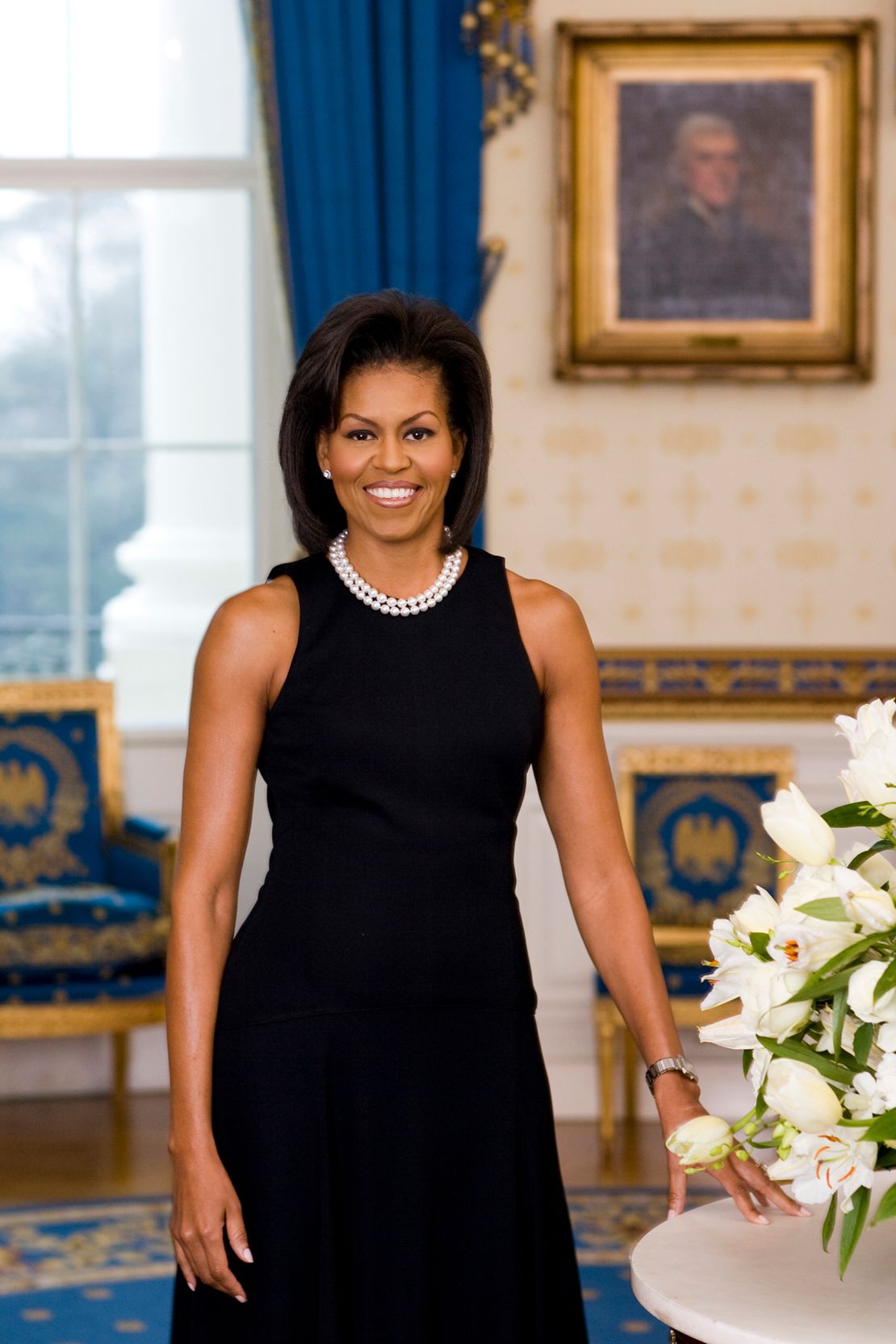 Michelle Obama poses for her official portrait in the Blue Room of the White House in February 2009.