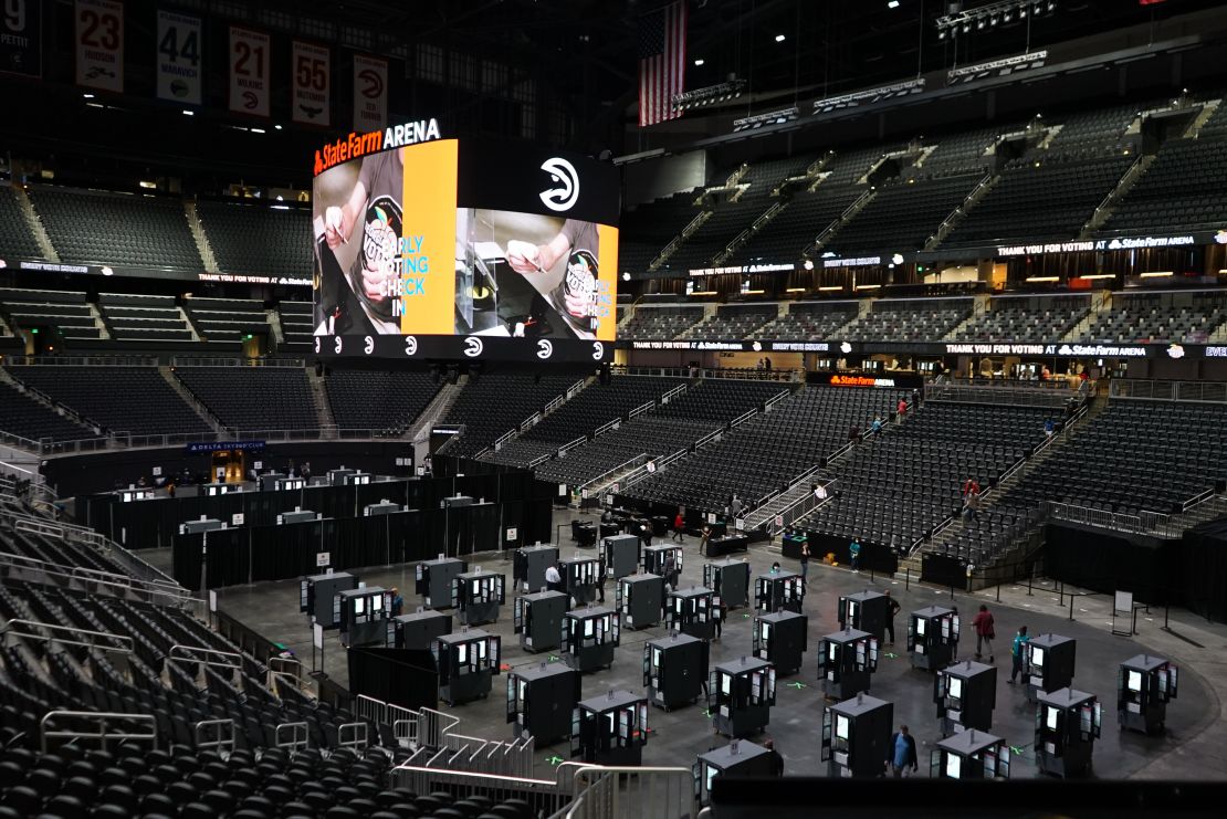 Voters cast their ballots inside of Atlanta's State Farm Arena, the largest early voting site in Georgia, on the first day of early voting on October 12, 2020. 