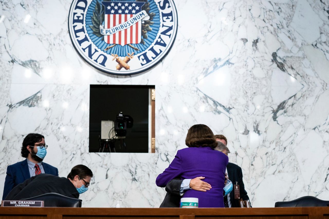 US Sen. Lindsey Graham, the chairman of the Senate Judiciary Committe, hugs US Sen. Dianne Feinstein, the top Democrat on the committee, after the fourth day of Barrett's confirmation hearings.