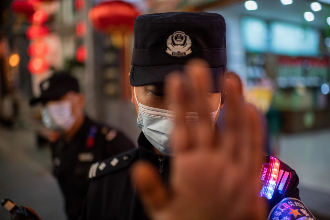 A police officer wears a face mask as a preventive measure against coronavirus. Harper was arrested near the start of the pandemic and would not learn about it for weeks. 