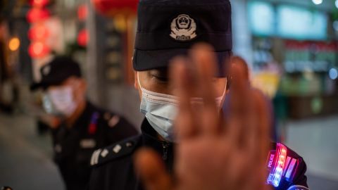 A police officer wears a face mask as a preventive measure against coronavirus. Harper was arrested near the start of the pandemic and would not learn about it for weeks. 