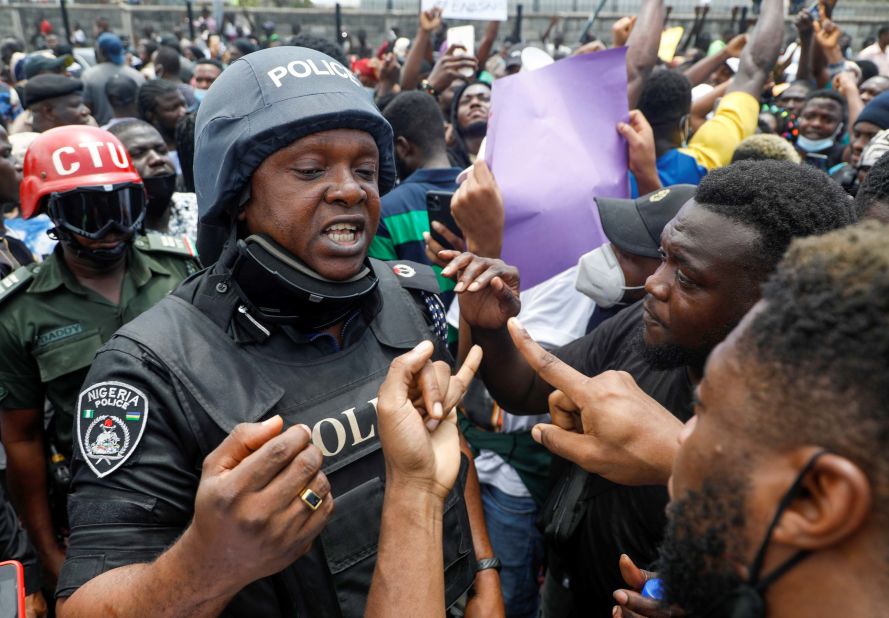 Demonstrators talk to a police officer during a protest in Lagos on October 12.