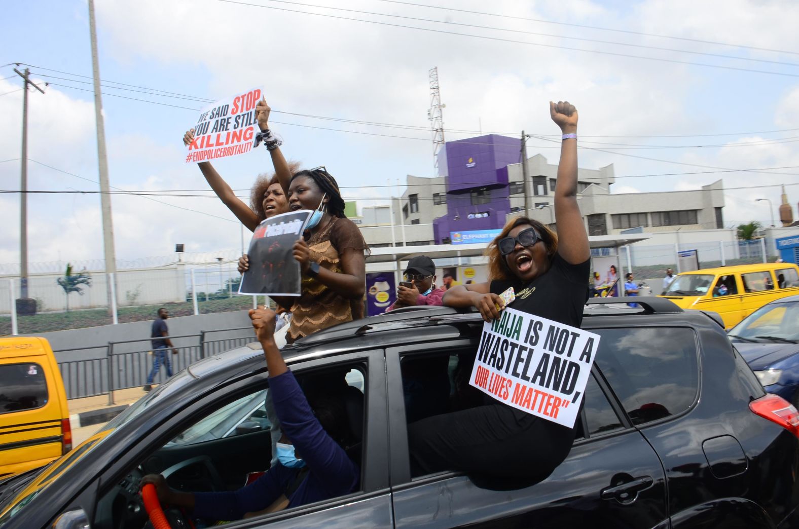 People protest from a car in Ikeja on October 13.