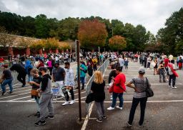 Hundreds of people wait in line for early voting on Monday, Oct. 12, 2020, in Marietta, Georgia. 