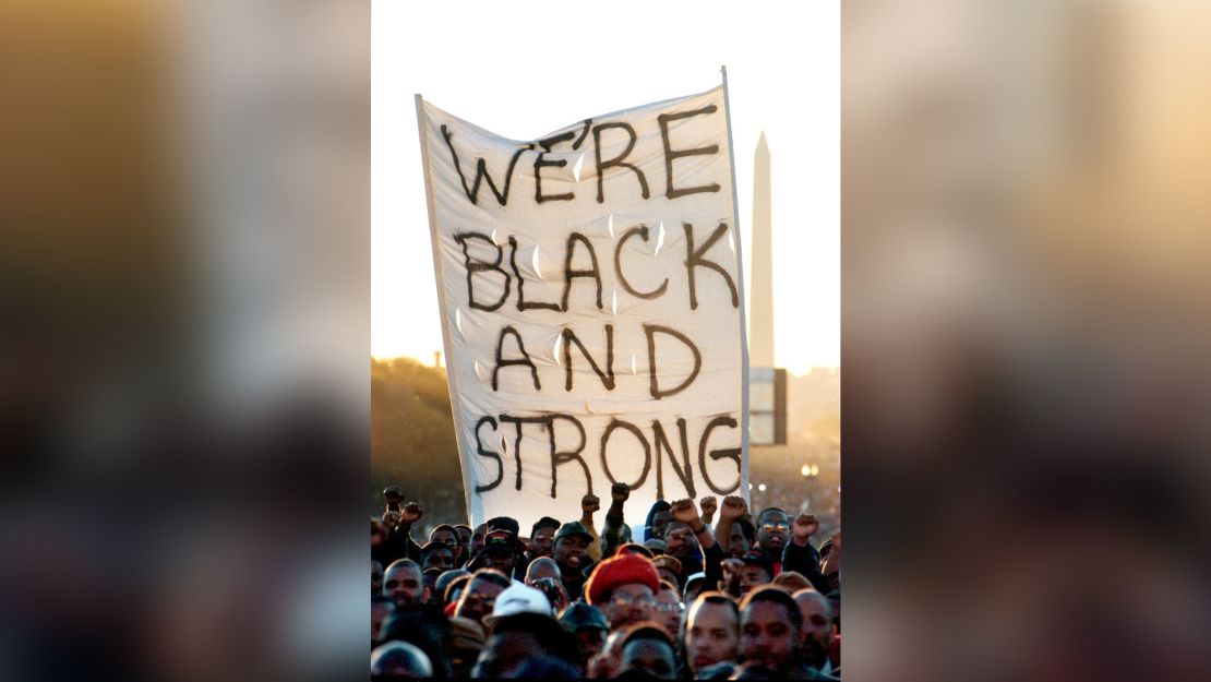 Men follow Farrakhan in an affirmation with raised fists near the end of the march. 