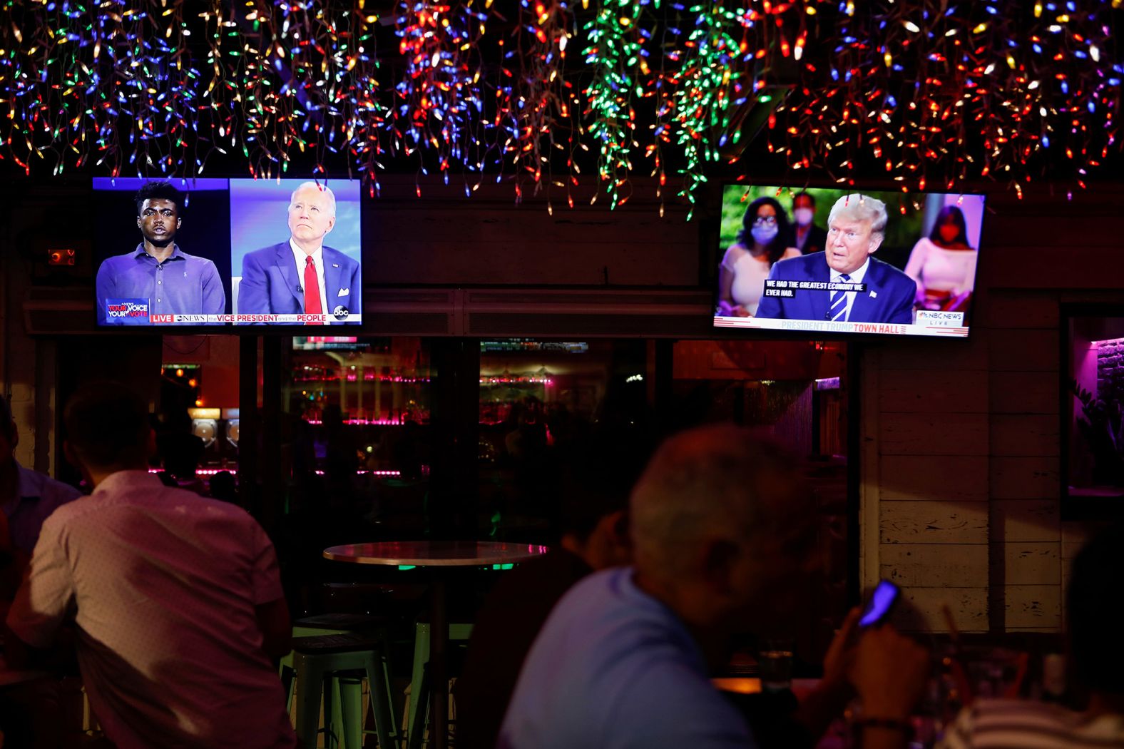 Television monitors show both town halls at the Luv Child restaurant in Tampa, Florida.