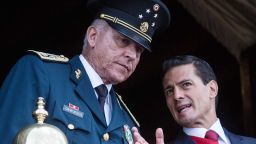 Former Mexican President Enrique Pena Nieto and former Defense Secretary Salvador Cienfuegos Zepeda watch the annual military parade at  Zocalo main square, in Mexico City, Mexico. Zepeda was detained by US authorities at the Los Angeles International airport.