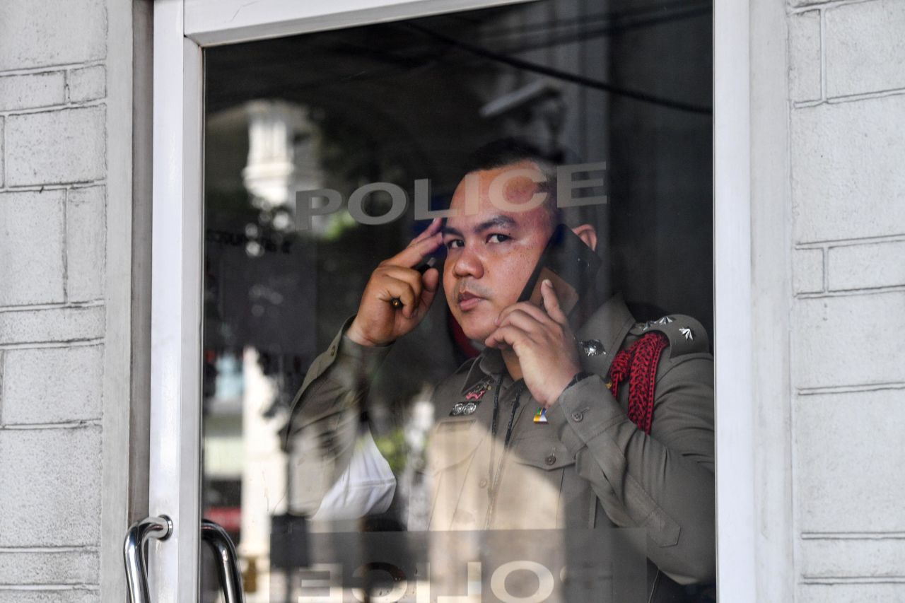 A policeman looks on from his booth in Bangkok on October 15.