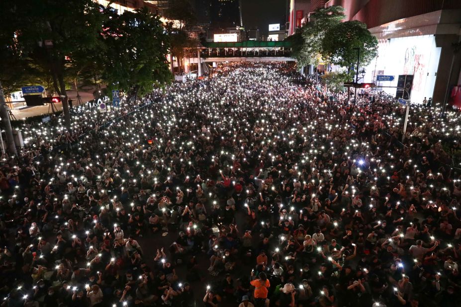 Protesters shine lights from their phones during a demonstration in Bangkok on October 15.