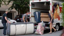 NEW YORK, NEW YORK - SEPTEMBER 12: People wearing masks load furniture into a U-haul moving truck as the city continues Phase 4 of re-opening following restrictions imposed to slow the spread of coronavirus on September 12, 2020 in New York City. The fourth phase allows outdoor arts and entertainment, sporting events without fans and media production. (Photo by Alexi Rosenfeld/Getty Images)