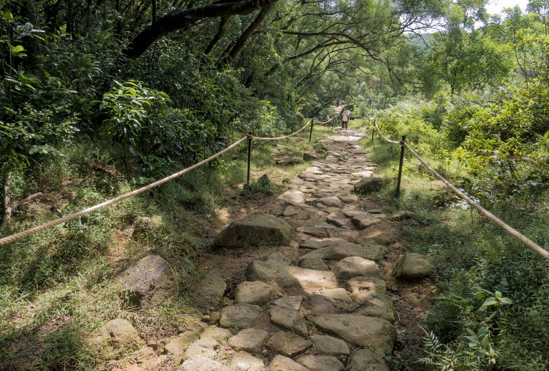 A woman walks on a recently repaired trail in the Ma On Shan Country Park, Hong Kong, on October 16, 2020.