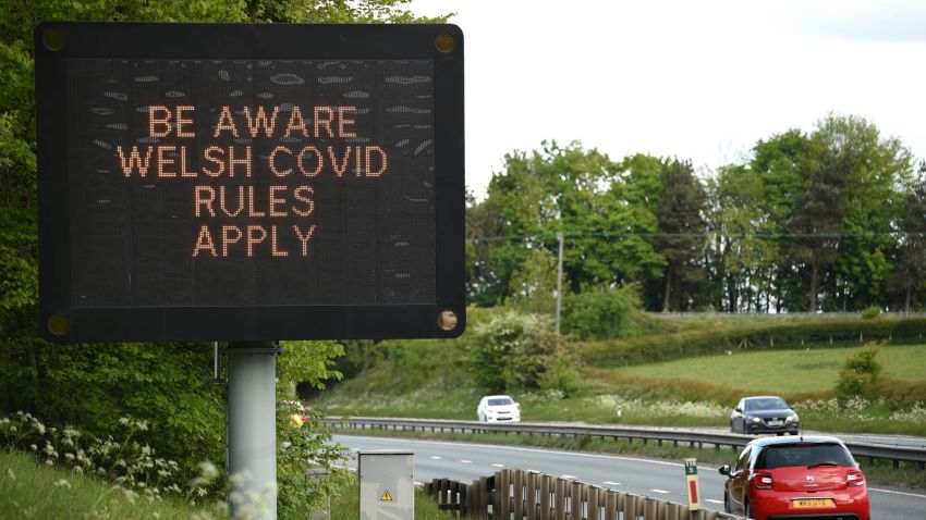 A sign notifying travellers to observe Wales' Covid-19 rules is displayed alongside the A55 motorway near Flint, north Wales on May 16, 2020, following an easing of lockdown rules in England during the novel coronavirus COVID-19 pandemic. - People are being asked to "think carefully" before visiting national parks and beaches on the first weekend since coronavirus lockdown measures were partially eased in England. (Photo by Oli SCARFF / AFP) (Photo by OLI SCARFF/AFP via Getty Images)