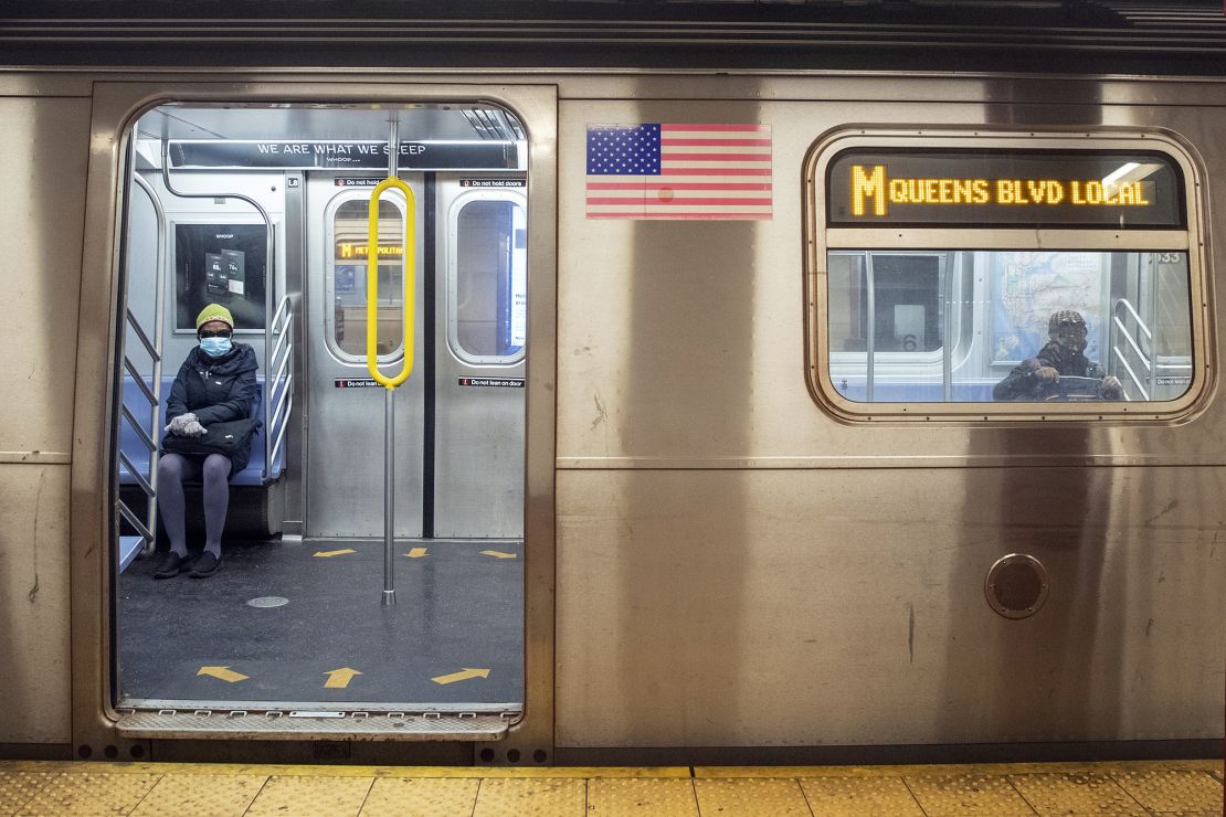 Commuters wear face masks as they ride the M train on April 10 in New York.