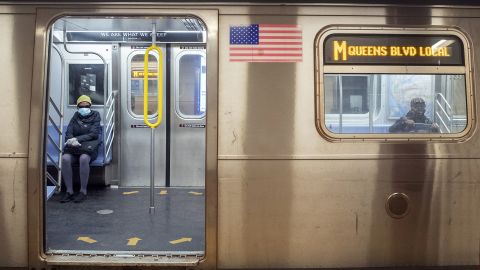 Commuters wear face masks as they ride the M train on April 10 in New York.