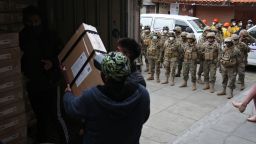 Employees of the Electoral Court, guarded by the Military Police, load a truck with electoral material to be distributed for Sunday's general election, in La Paz, on October 16, 2020. - Landlocked Bolivia elects a new president on October 18, 2020 after a 2019 poll was annulled and follow-up elections postponed twice amid the COVID-19 novel coronavirus pandemic. (Photo by Luis GANDARILLAS / AFP) (Photo by LUIS GANDARILLAS/AFP via Getty Images)