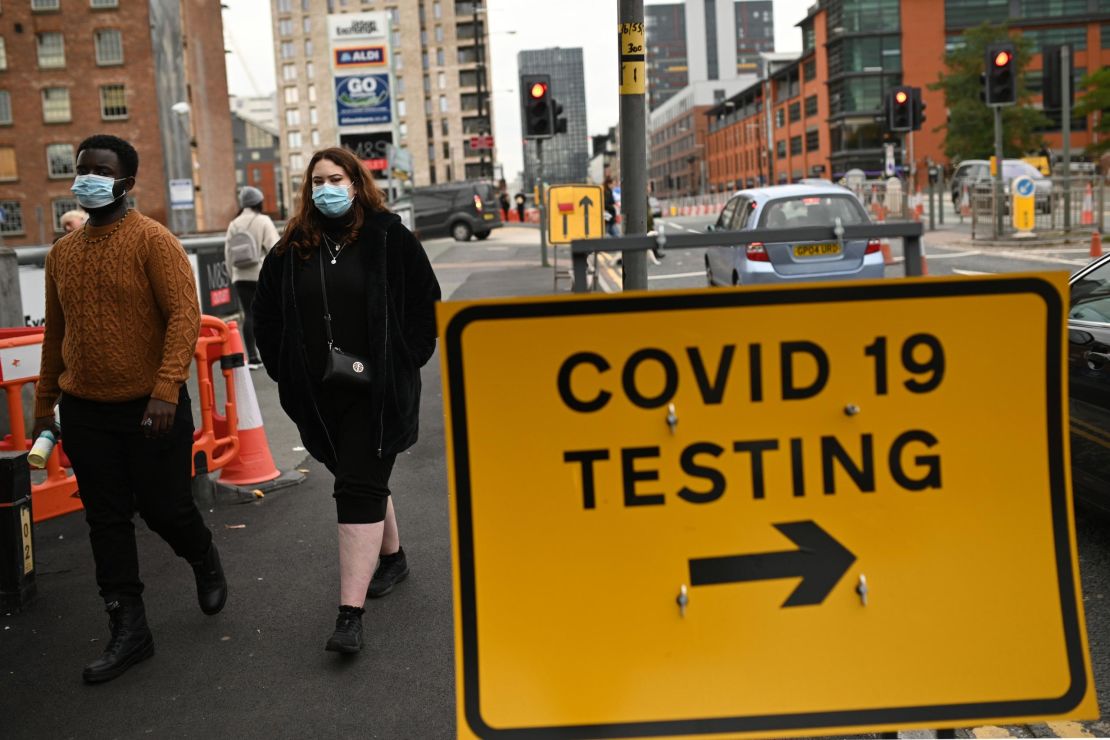 Pedestrians walk past a Covid-19 testing sign in Manchester on October 17.