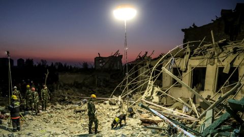 Search and rescue teams in Ganja, Azerbaijan, work at the blast site hit by a rocket during the fighting over the breakaway region of Nagorno-Karabakh on October 17, 2020.