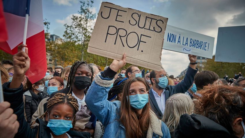 PARIS, FRANCE - OCTOBER 18: Protestors hold 'Je Suis Prof' placards during an anti-terrorism vigil at Place de La Republique for the death of Samuel Paty who was murdered in a terrorist attack in the suburbs of Paris on October 18, 2020 in Paris, France. Je Suis Prof has emerged reminiscent to Je Suis Charlie which emerged in the aftermath of the 2015 terrorist attack on the newspaper Charlie Hebdo. France launched an anti-terrorism investigation after the October 16 incident where police shot the 18 year-old assailant who decapitated the history-geography teacher for having shown a caricature of prophet Mohamed as an example of freedom of speech at the College Bois d'Aulne middle-school.  (Photo by Kiran Ridley/Getty Images)