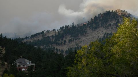  The CalWood fire burns on a hillside sending up a large plume of smoke near Buckingham Park northwest of Boulder.