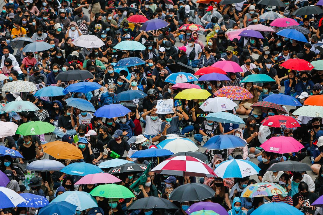 Protesters wearing face masks gather with their umbrellas during a demonstration in Nonthaburi province.
