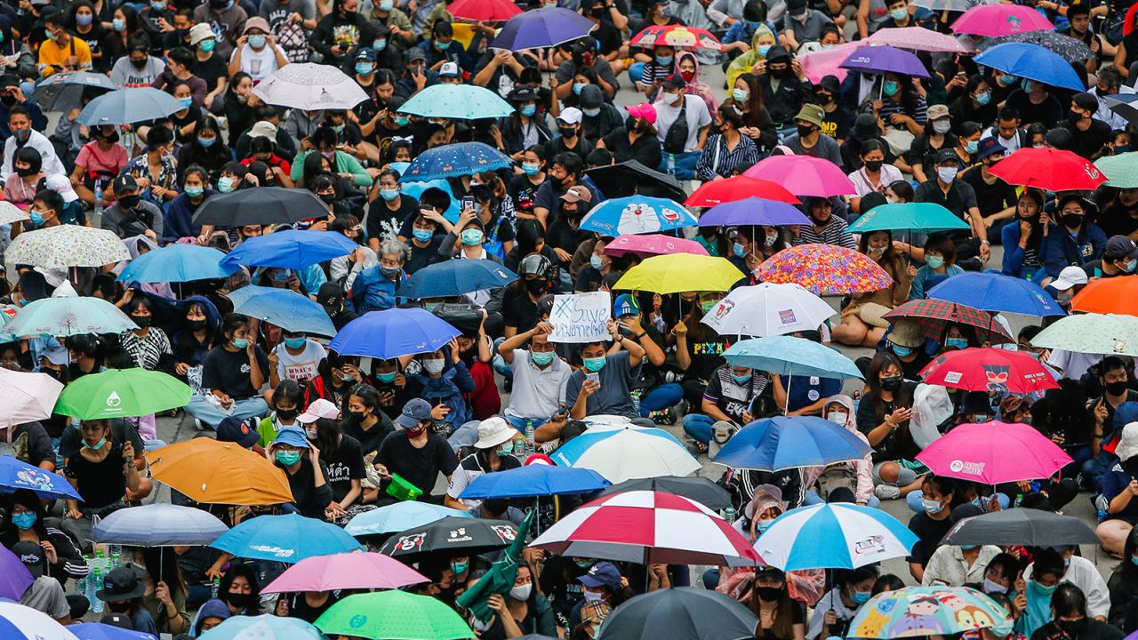 Protesters wearing face masks gather with their umbrellas during a demonstration in Nonthaburi province.