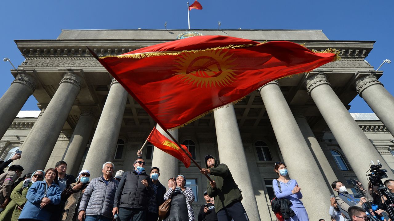 Supporters of the newly appointed Prime Minister Sadyr Japarov wave Kyrgyz flags during a rally in Bishkek on October 14, 2020.