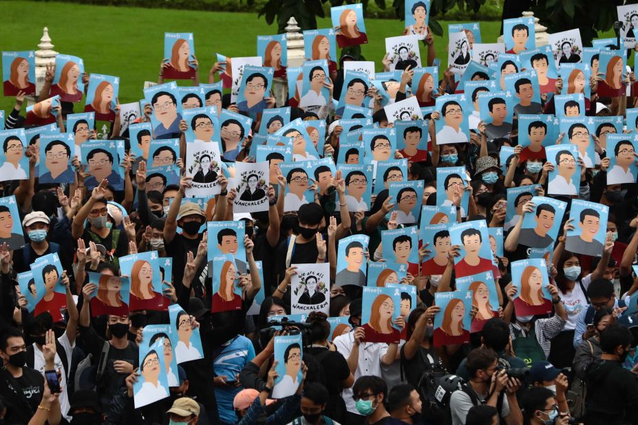 Protesters hold up posters of various activists during an anti-government rally at Victory Monument in Bangkok on October 18.