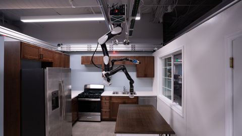 To help people as they age, Toyota Research Institute (TRI) is developing human-assist robots in its labs in California. This "gantry robot" is adapted for the home from a style more often seen in assembly and manufacturing lines. Since these robots hang from the ceiling like a bat, they save floor space and can reach other machines and parts easily from above. This TRI robot is able to complete tasks such as loading the dishwasher.