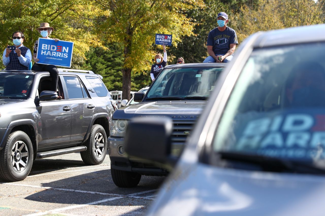 Attendees look on from their vehicles as Biden delivers remarks in Durham.