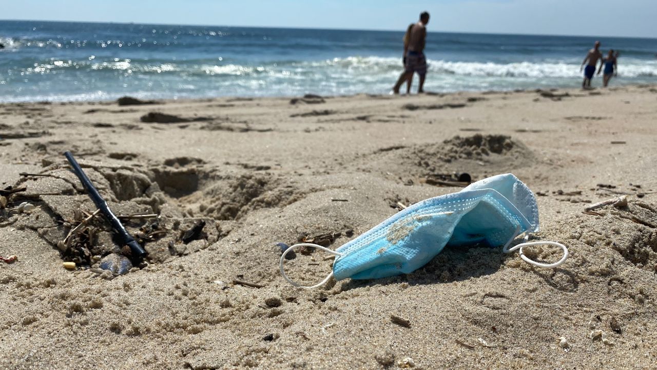 PPE waste, including disposable masks, found on a beach in New Jersey.