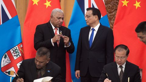 Fiji's Prime Minister Josaia Voreqe "Frank" Bainimarama talks with Chinese Premier Li Keqiang during a signing ceremony at the Great Hall of the People in Beijing on May 16, 2017.