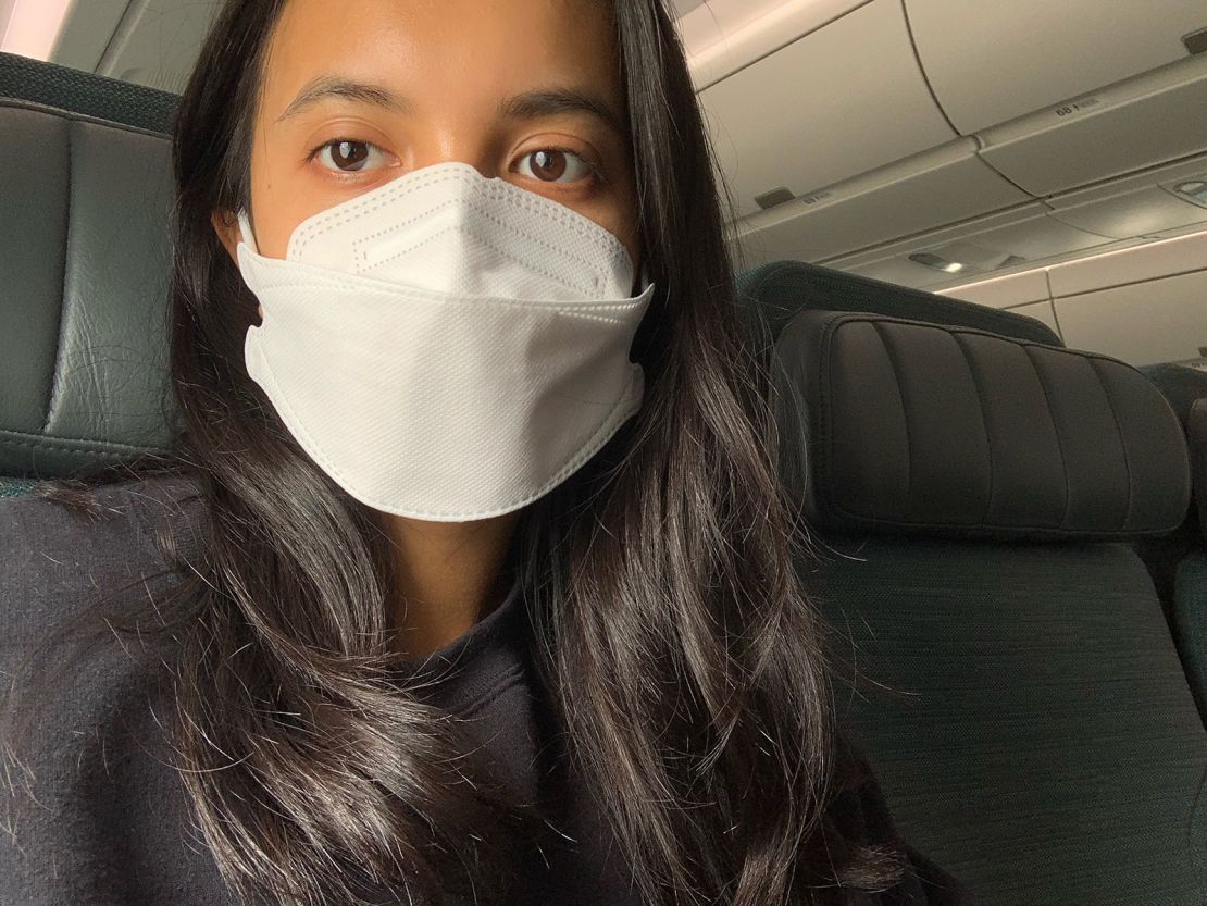 Karina Tsui, mask on, prepares to fly from the United States to Hong Kong.