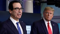 U.S. President Donald Trump, right, listens as Steven Mnuchin, U.S. Treasury secretary, speaks during a Coronavirus Task Force news conference at the White House in Washington, D.C., U.S., on Monday, April 13, 2020. Some of the nations most powerful governors said they would form regional alliances to coordinate reopening schools and businesses after the coronavirus outbreak subsides, setting up a potential clash with the president, who says that he alone has that authority. Photographer: Yuri Gripas/Abaca/Bloomberg via Getty Images
