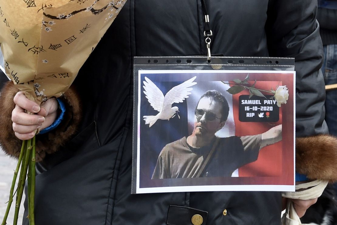  A woman holds a picture of Samuel Paty, at the Place de la Liberte in Lille on October 18.