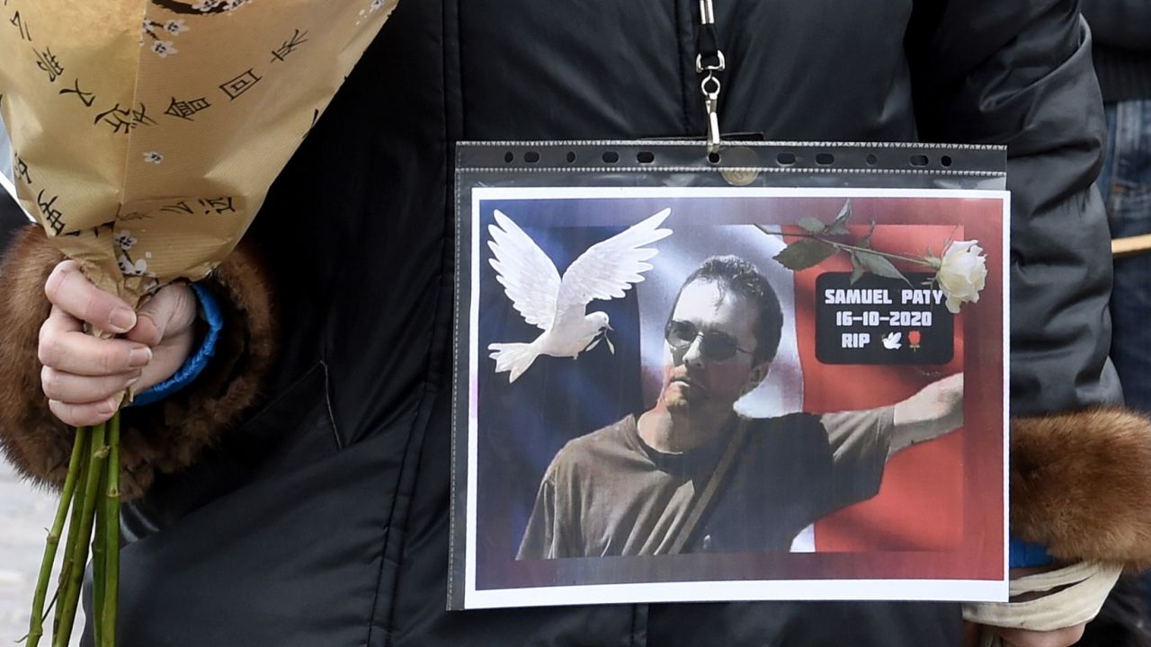  A woman holds a picture of Samuel Paty, at the Place de la Liberte in Lille on October 18.