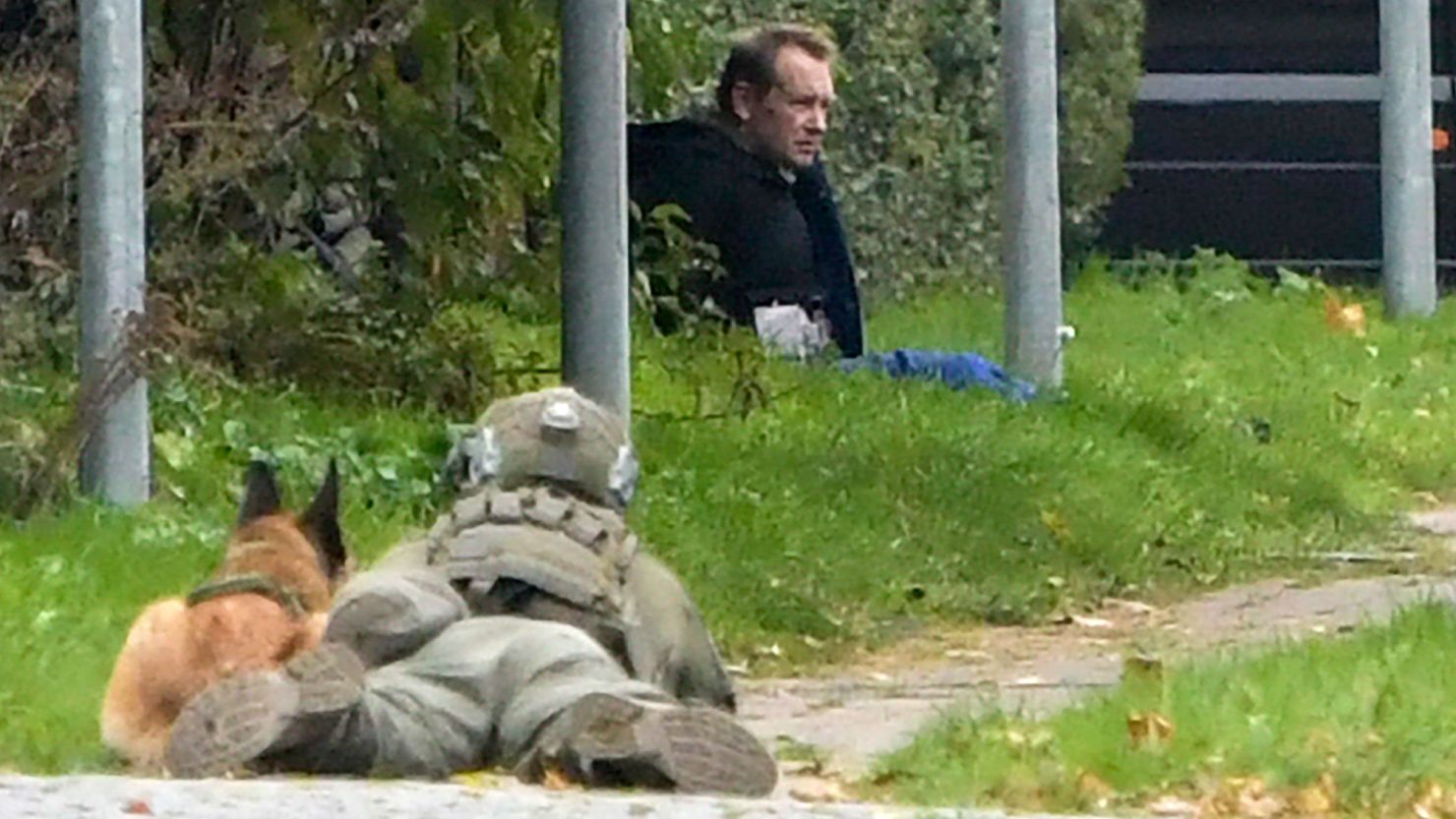 A police marksman and his dog observes Peter Madsen as he attempts to break out of prison in Albertslund, Denmark.